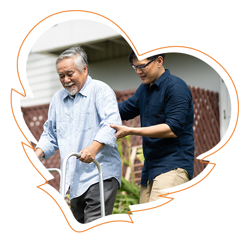 The image features two individuals engaged in an outdoor activity  one person is assisting another who appears to be using a mobility aid, possibly for balance or support. Both individuals are smiling and seem to be enjoying their time together.