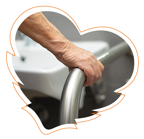 The image shows an elderly person s hand holding onto a stainless steel railing in a bathroom setting.